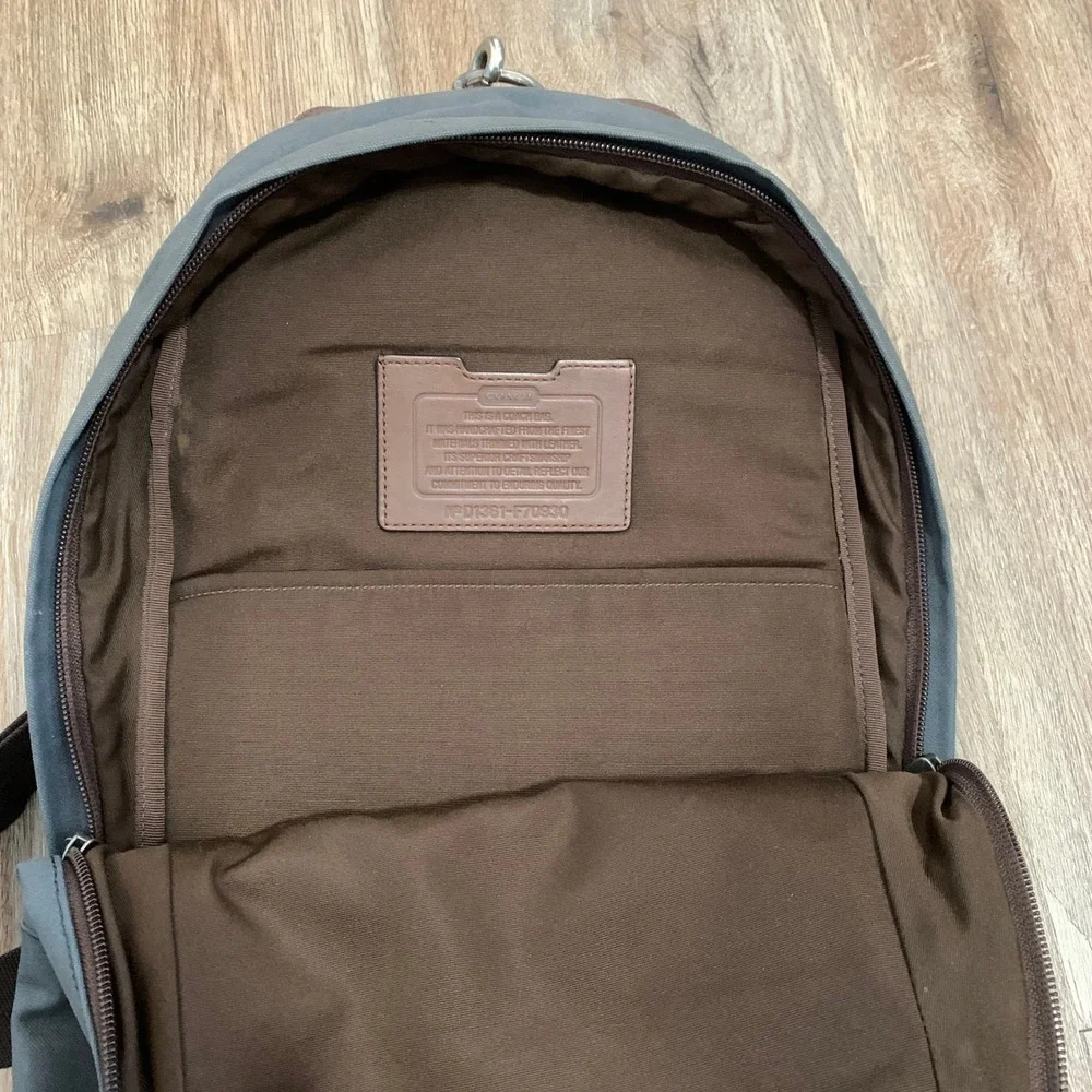 Coach 2013 canvas sling backpack in navy blue w/ brown leather panels - 13x18in‎